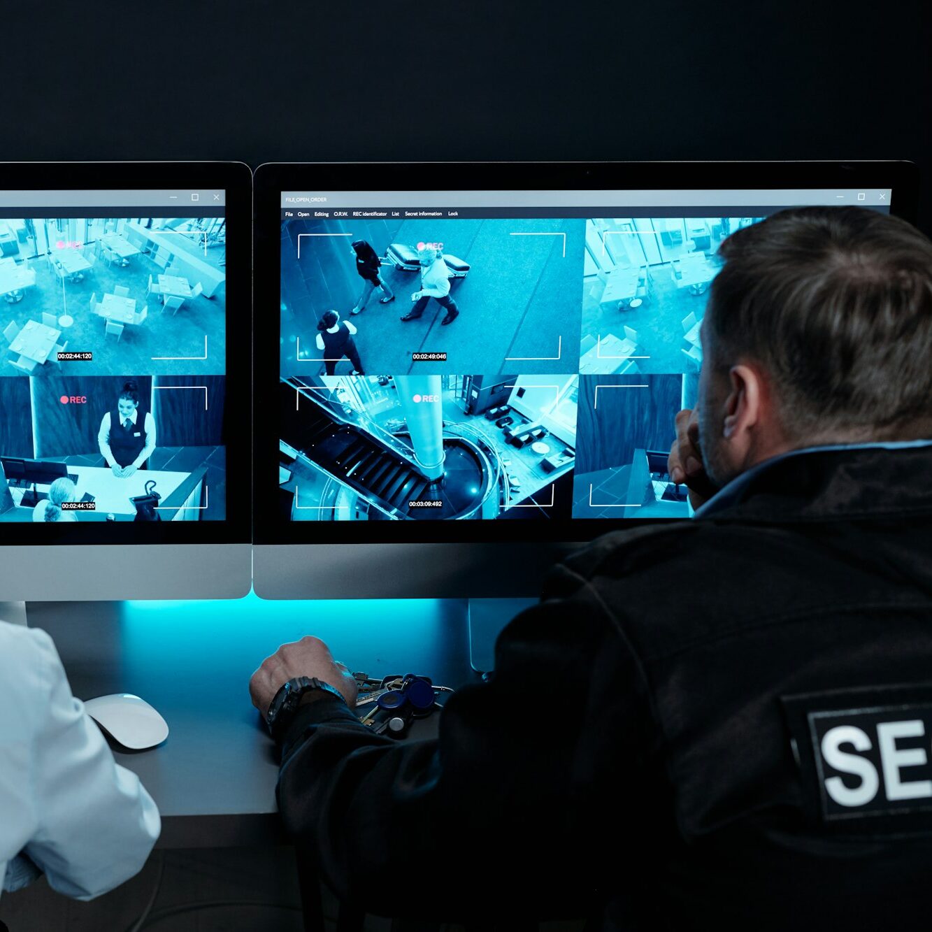 Two officers watching cctv video cameras